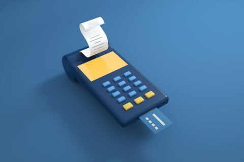 A blue card reader with a receipt printout and inserted card on a blue background.